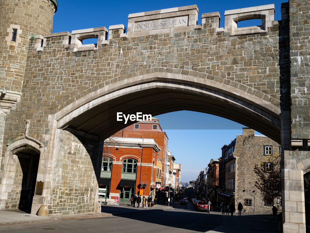 architecture, built structure, arch, building exterior, city, landmark, travel destinations, town, history, street, nature, the past, clear sky, transportation, sky, road, sunny, travel, bridge, building, day, ancient history, tourism, outdoors, sunlight, old, urban area, no people