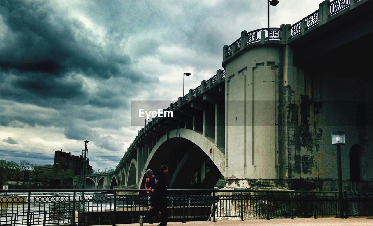 VIEW OF BRIDGE OVER RIVER AGAINST CLOUDY SKY