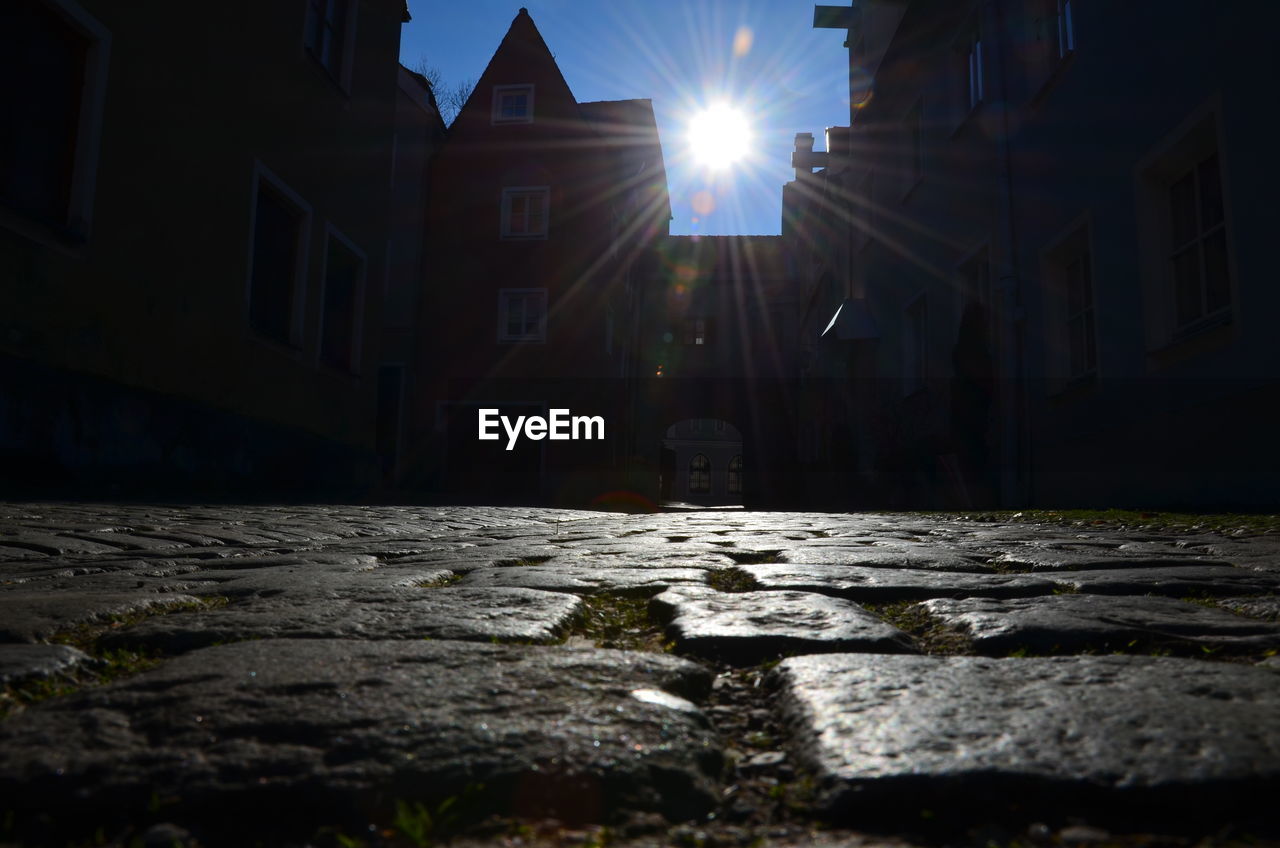 SURFACE LEVEL OF STREET BY BUILDINGS AGAINST SKY