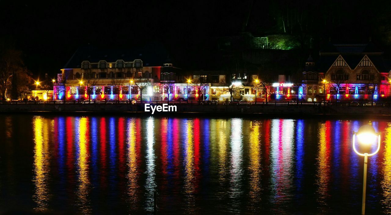 ILLUMINATED CITY BY WATER