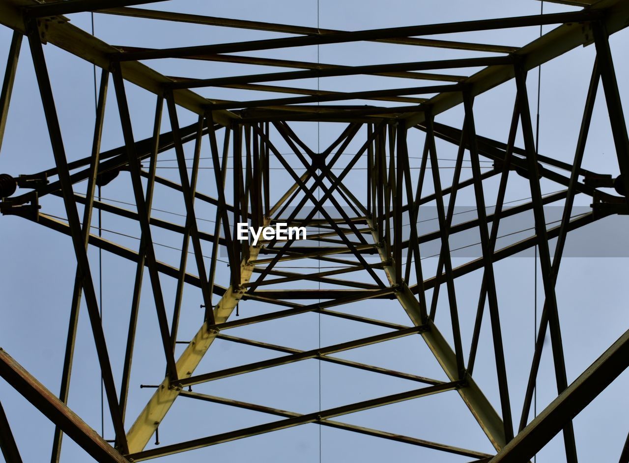 Low angle view of electricity pylon against sky