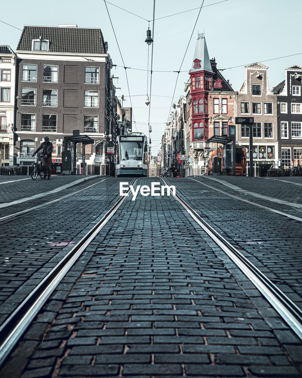 Railroad tracks amidst buildings in city against sky