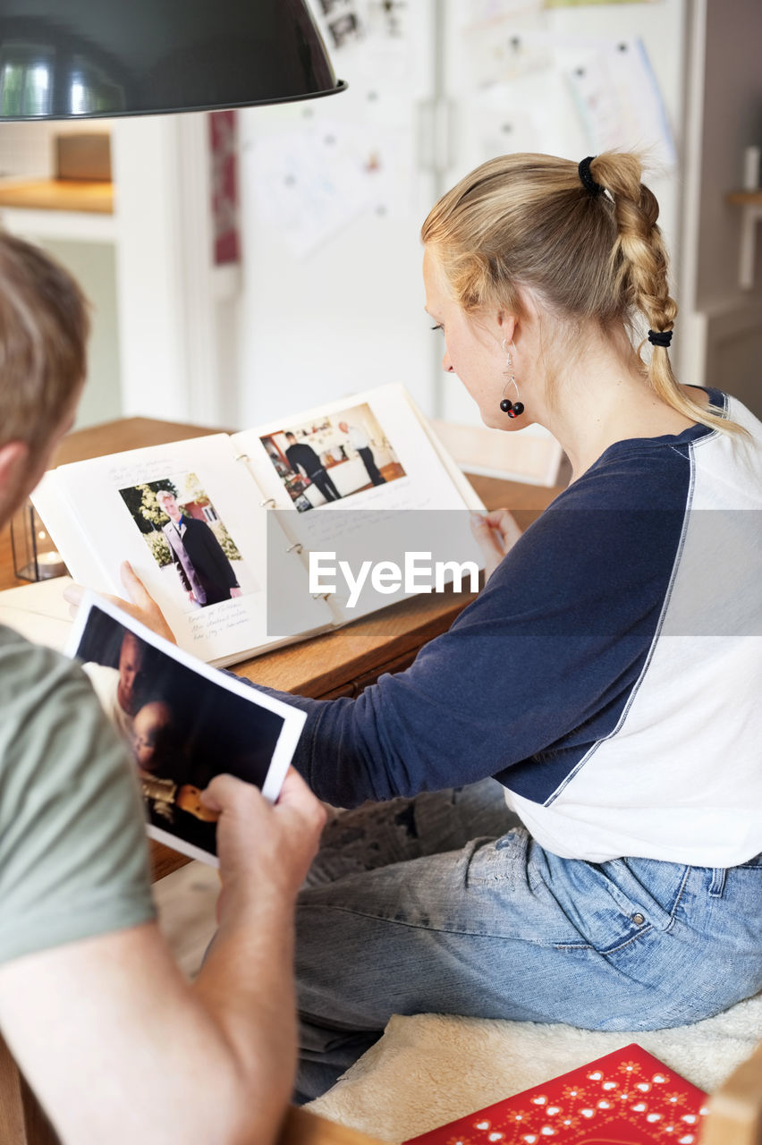 Man and woman looking trough photo album