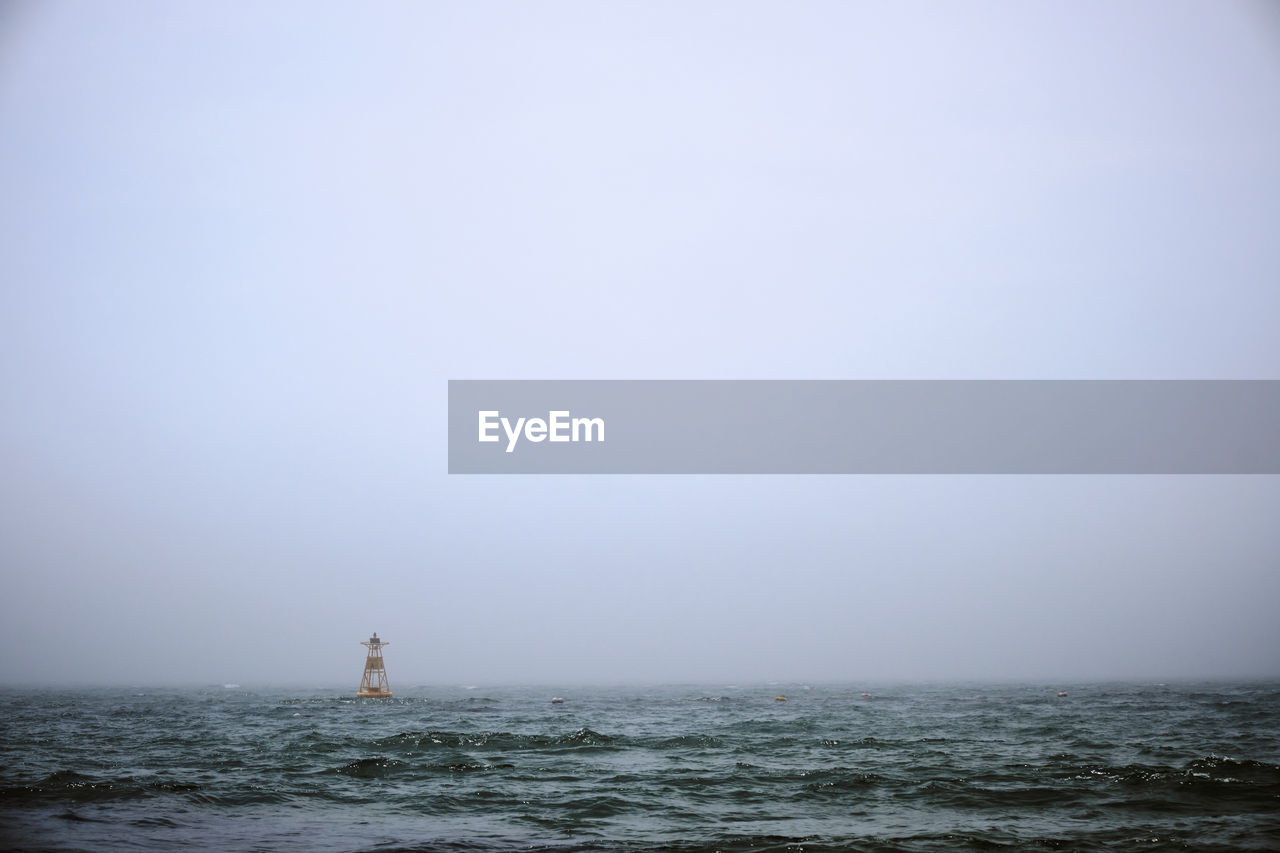 A shot of a buoy in the morning fog