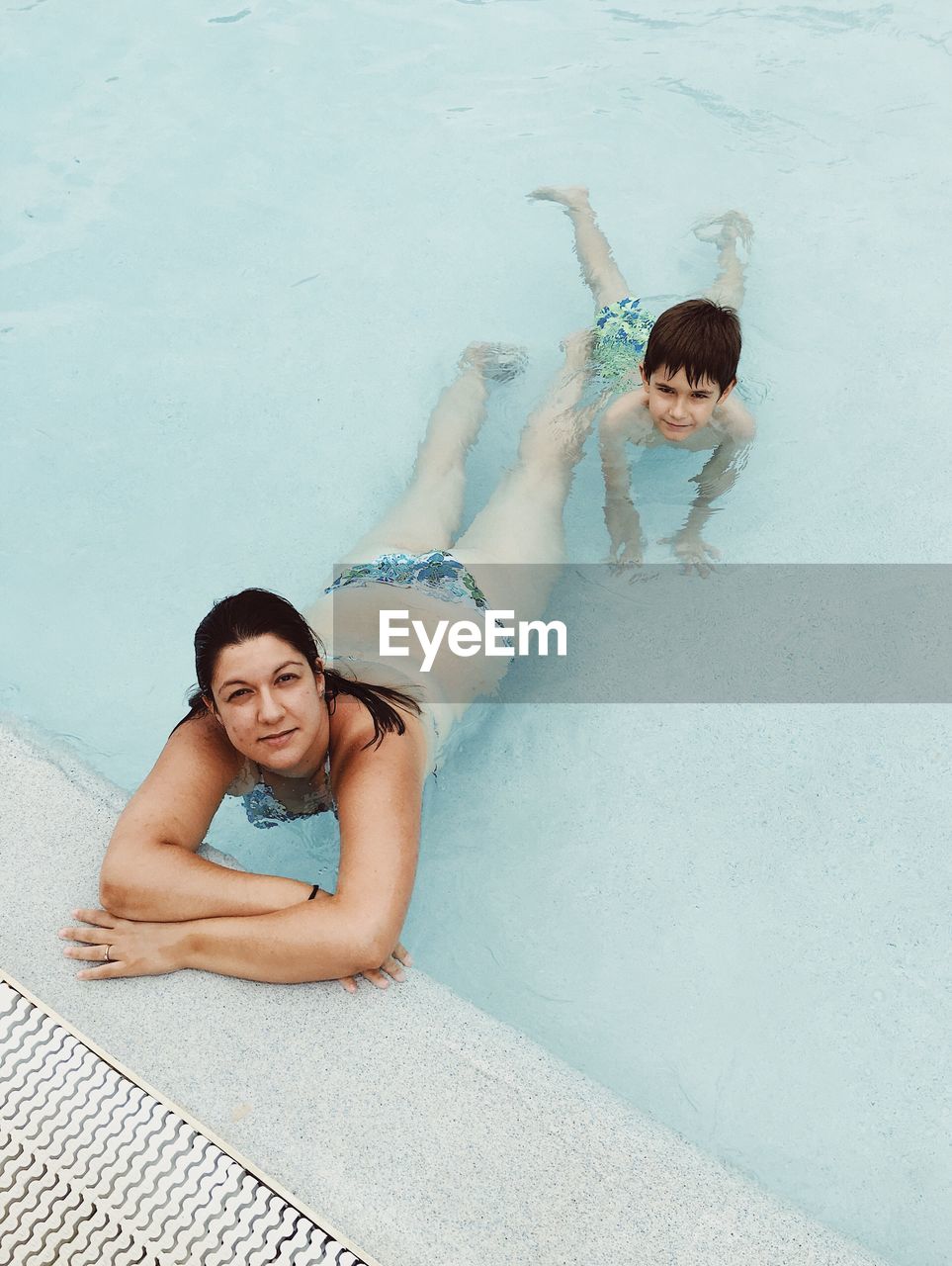 Portrait of woman with son in swimming pool