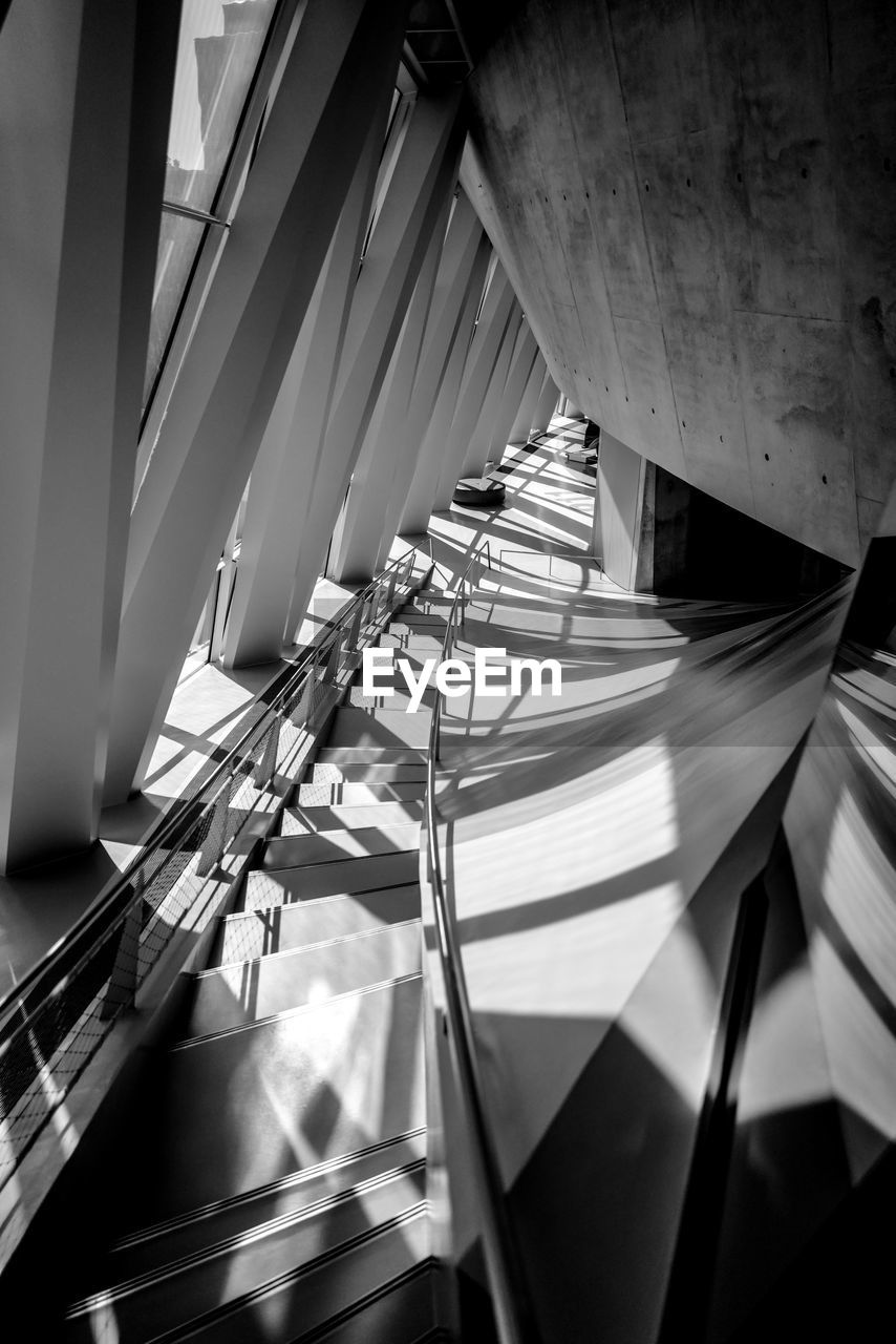 DIRECTLY BELOW SHOT OF SPIRAL STAIRCASE IN BUILDING