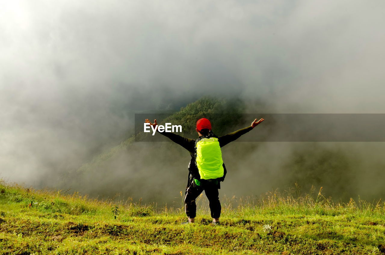 REAR VIEW OF PERSON ON FIELD