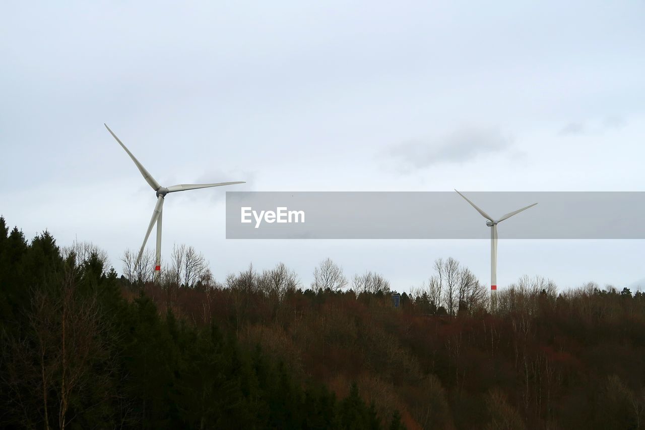 Windmill on field against sky