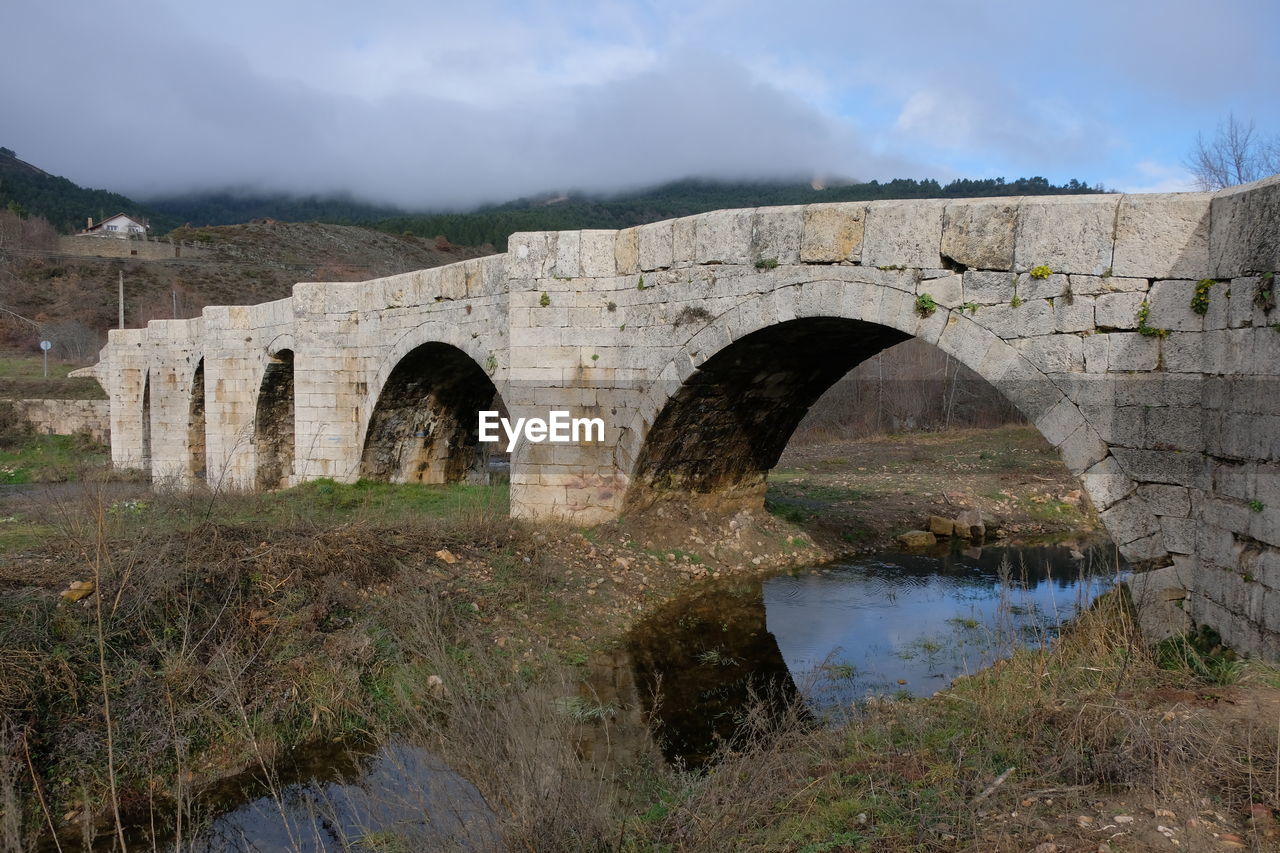 architecture, arch, bridge, water, built structure, aqueduct, nature, sky, history, arch bridge, no people, the past, cloud, river, environment, landscape, viaduct, plant, waterway, travel destinations, transportation, ancient, ancient history, wall, outdoors, travel, ruins, old, fortification, stone material, land, tree