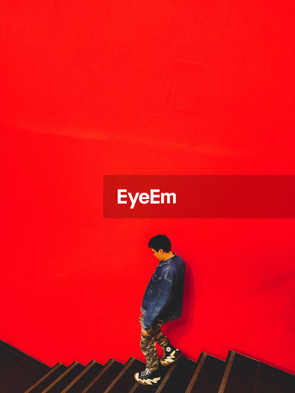 red, one person, full length, architecture, copy space, standing, built structure, adult, men, person, lifestyles, leisure activity, wall - building feature, light