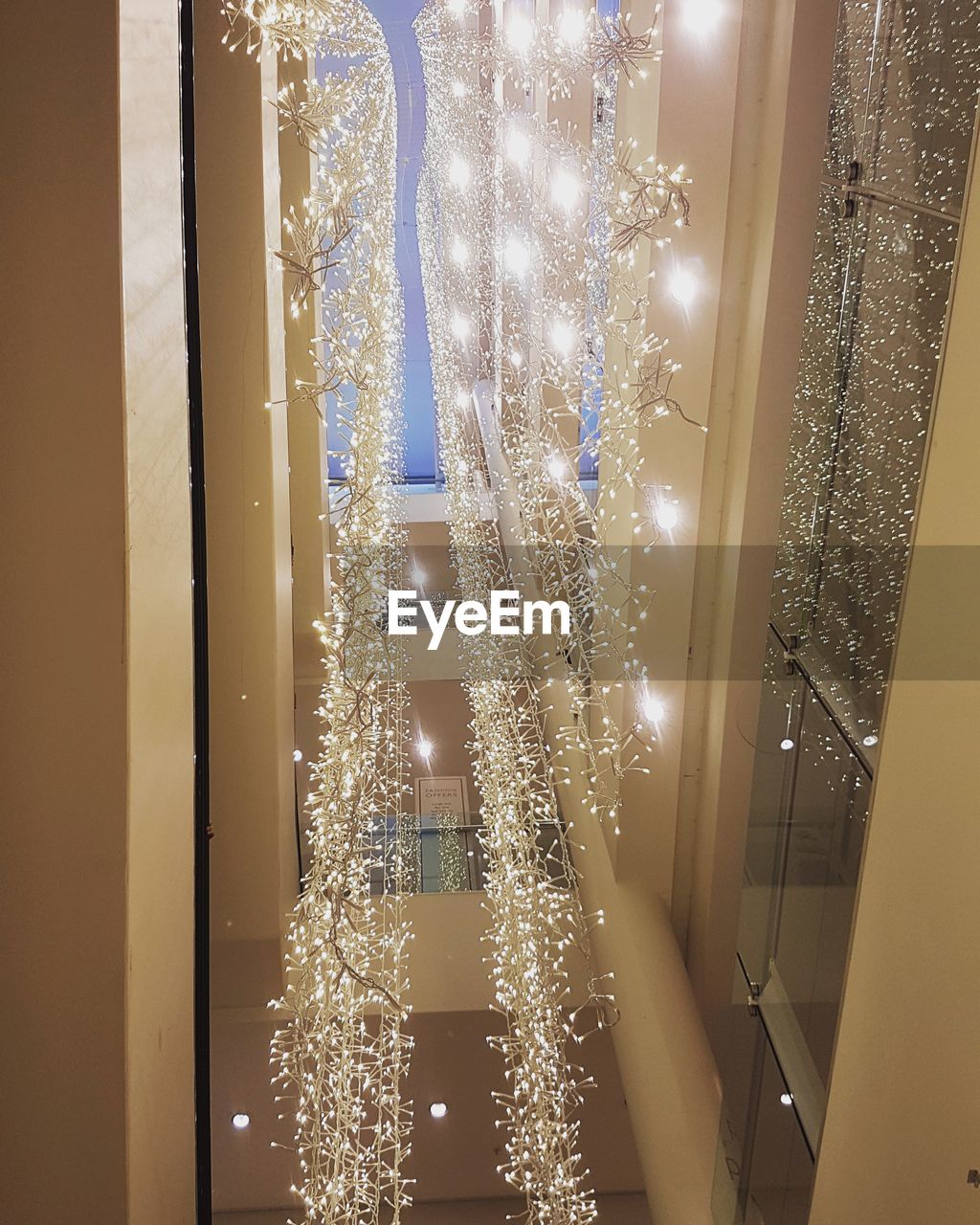 CLOSE-UP OF ILLUMINATED CHRISTMAS LIGHTS AT WINDOW