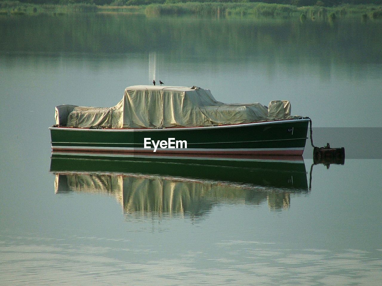 Full length of nautical vessel in reflection lake