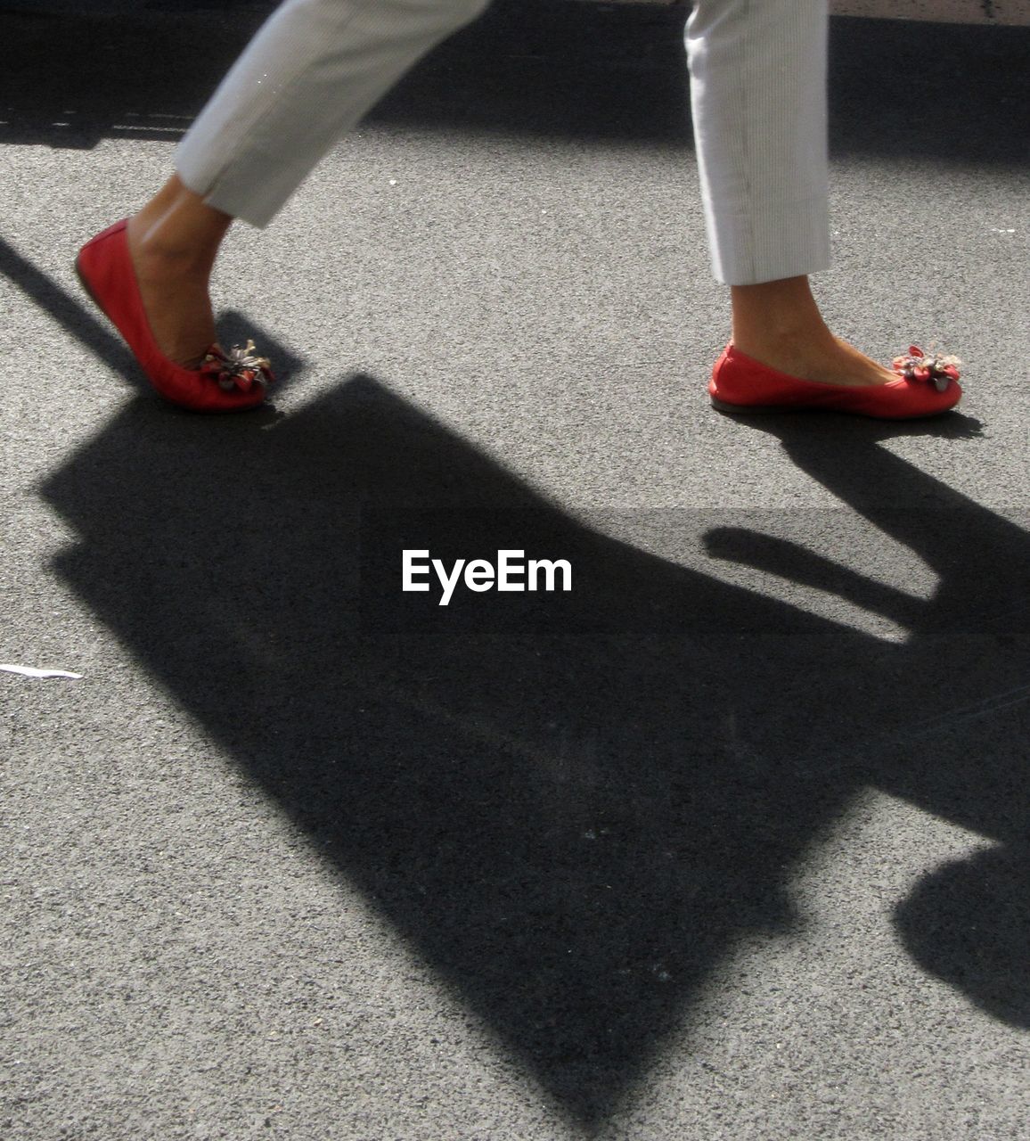 LOW SECTION OF PEOPLE WALKING ON ROAD