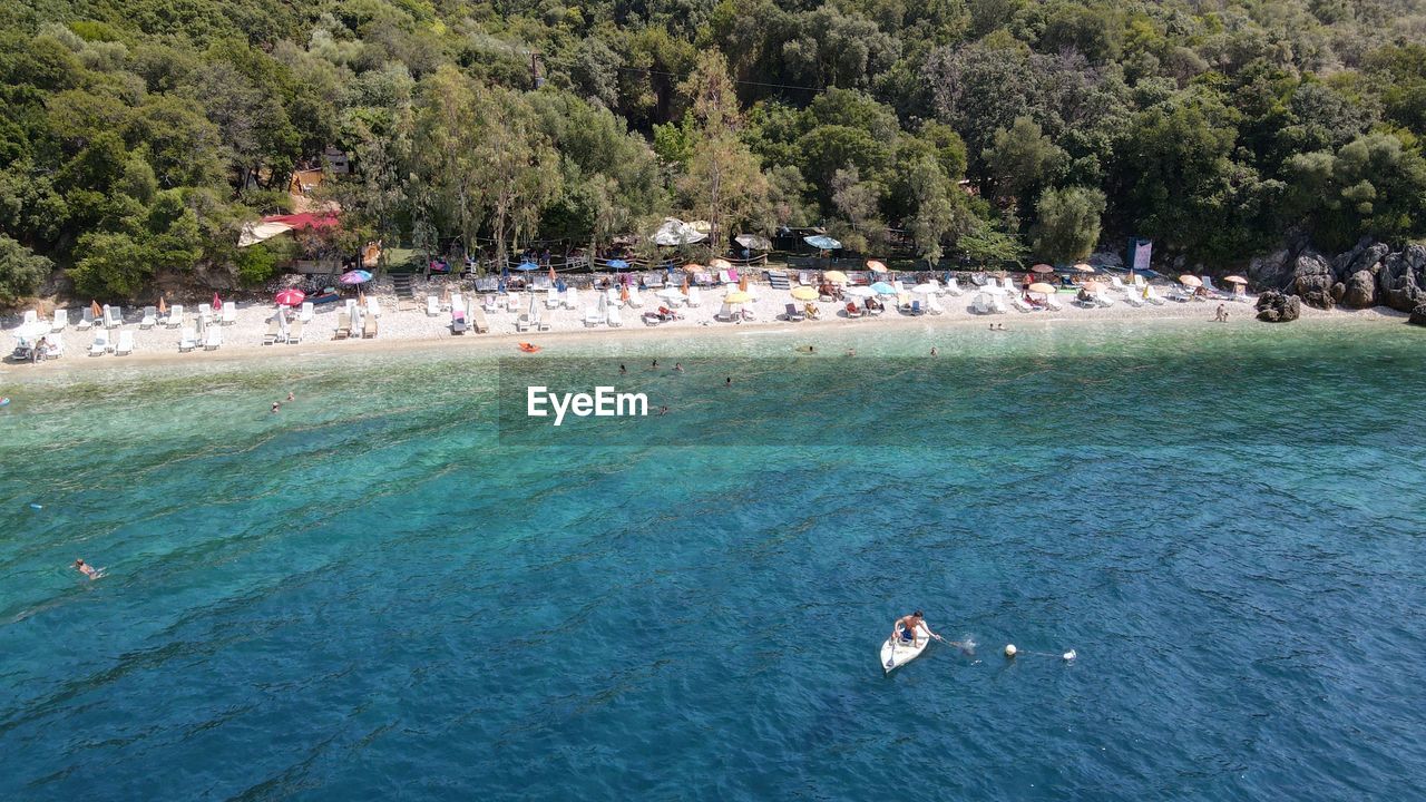 HIGH ANGLE VIEW OF PEOPLE BY SEA