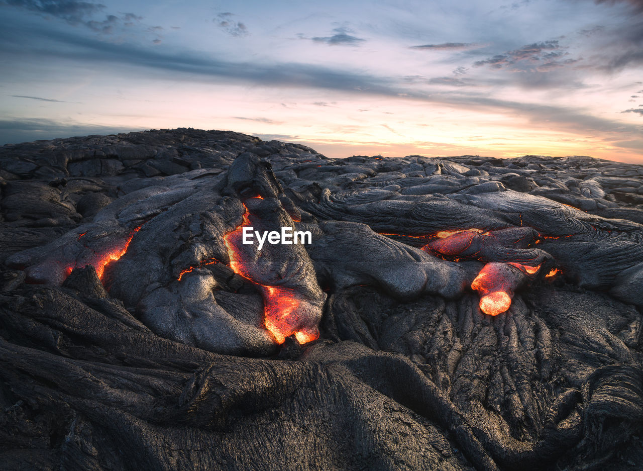 Scenic view of lava against sky during sunset