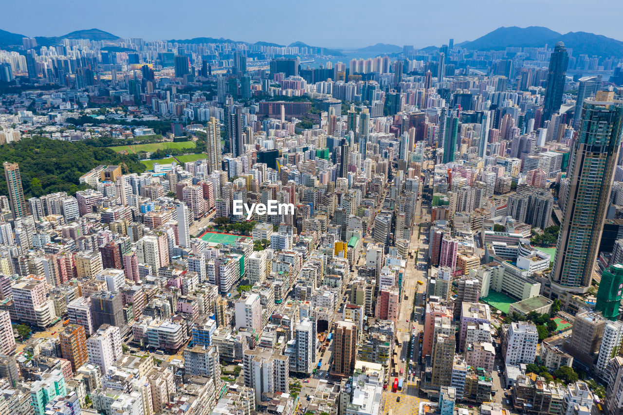 High angle view of modern buildings in city against sky