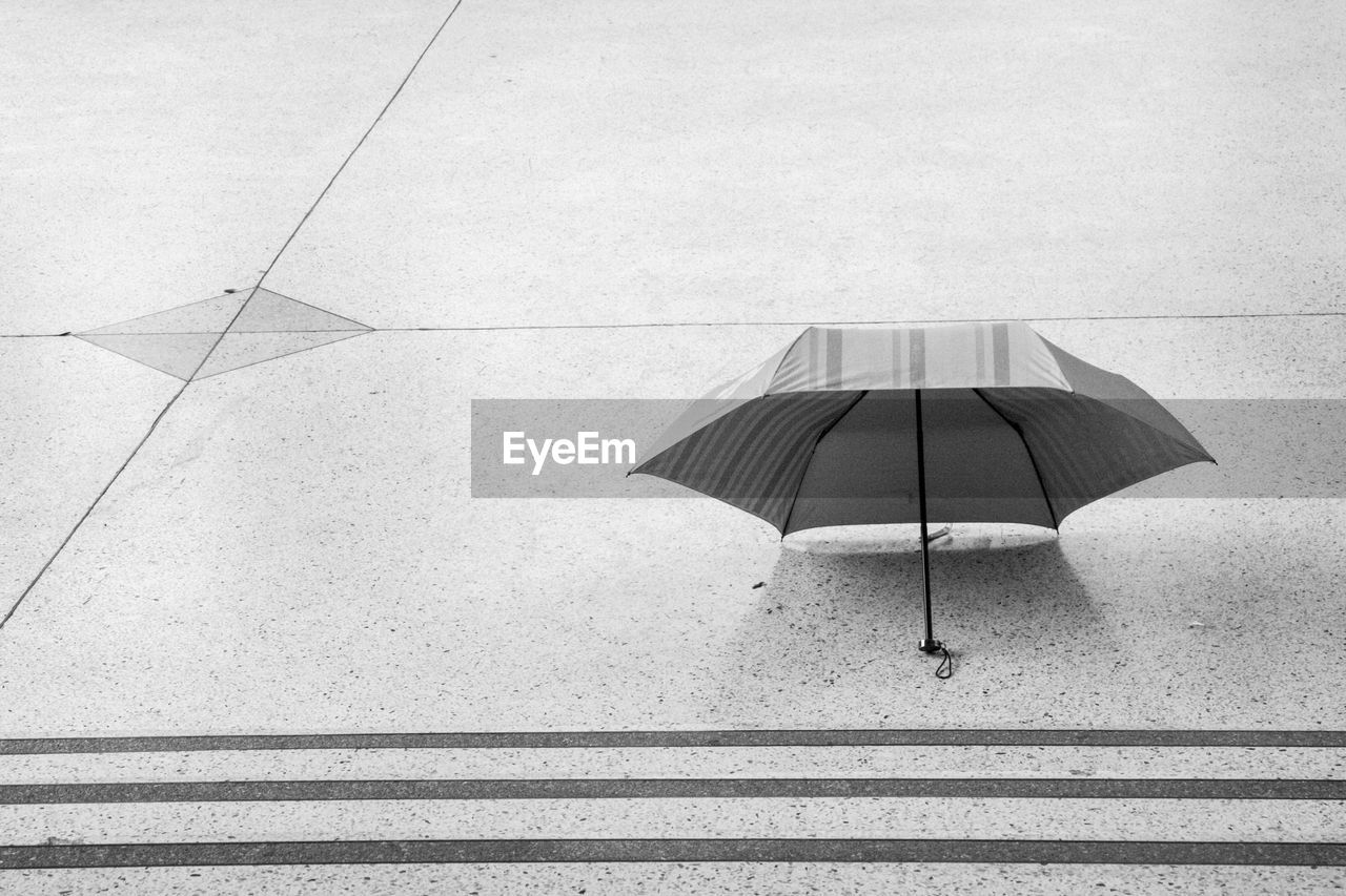 High angle view of umbrella on footpath