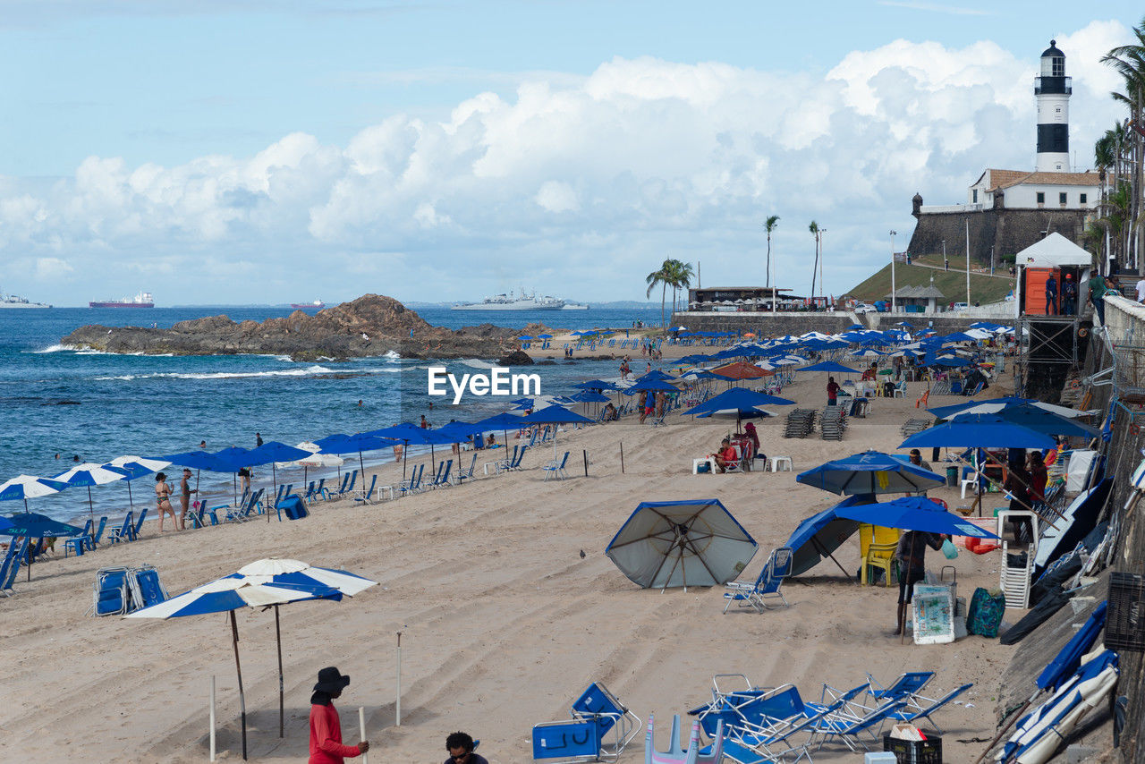 People on beach against sky