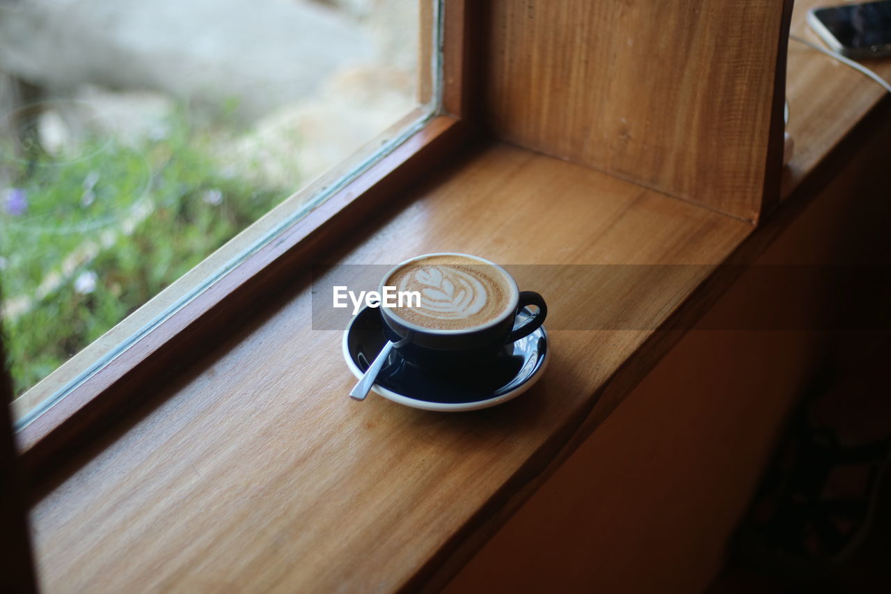 drink, coffee, cup, food and drink, mug, coffee cup, refreshment, indoors, window, wood, table, no people, hot drink, day, high angle view, crockery, still life, home interior, selective focus, glass