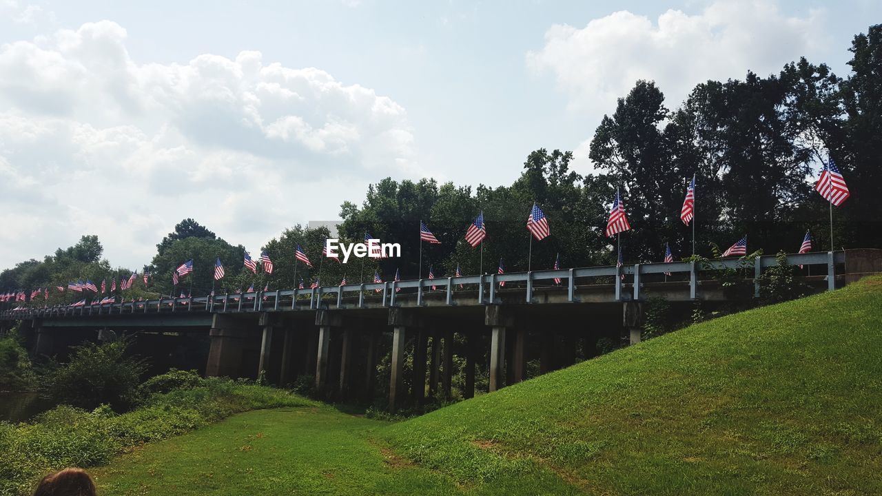 Flags waving in the wind on bridge