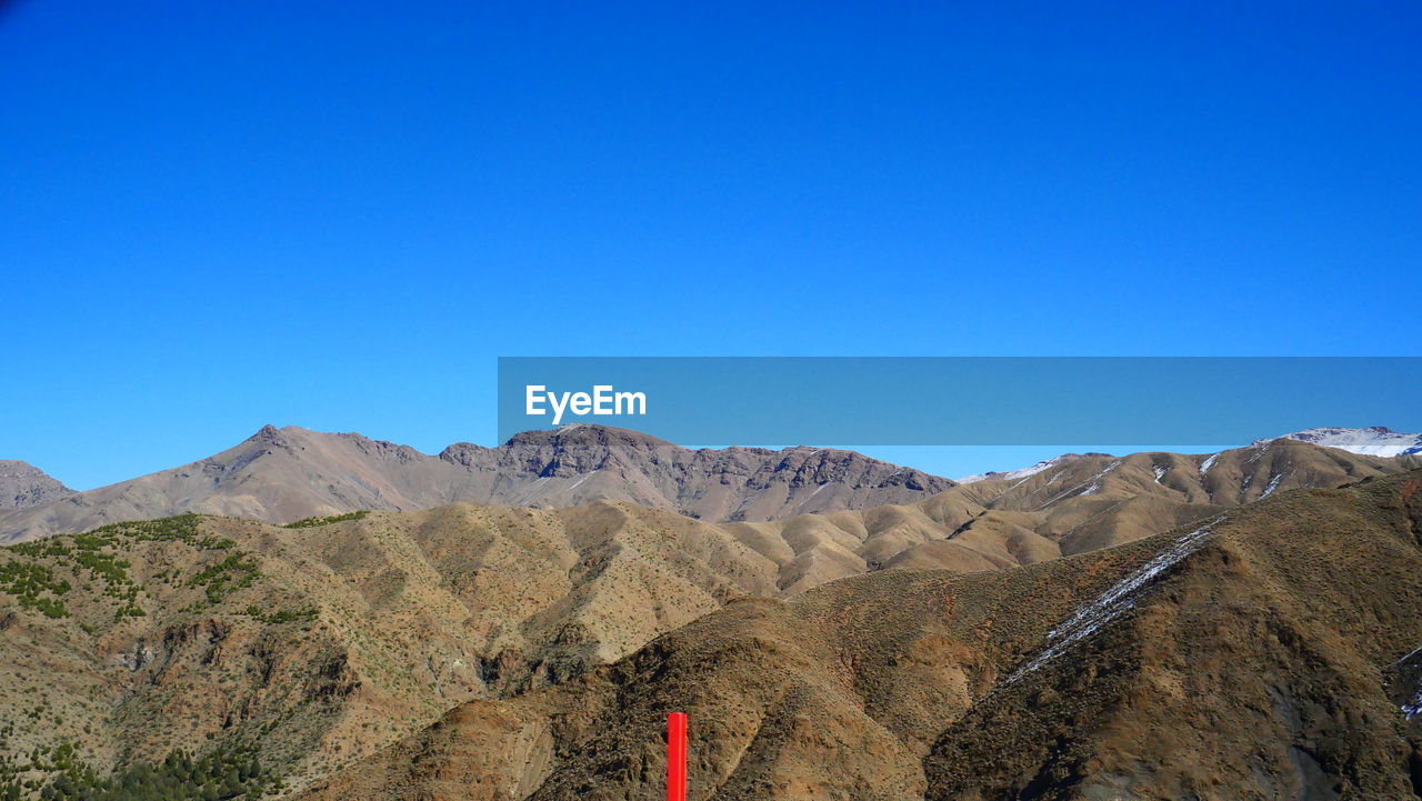 SCENIC VIEW OF MOUNTAINS AGAINST BLUE SKY