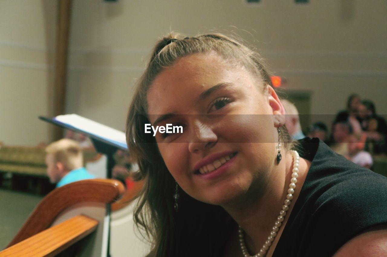 Portrait of smiling woman at classical concert