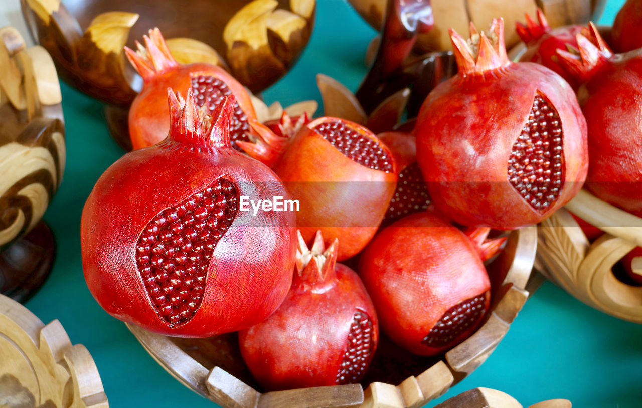 Heap of wooden pomegranate ornaments for sale at the vernissage market in yerevan, armenia