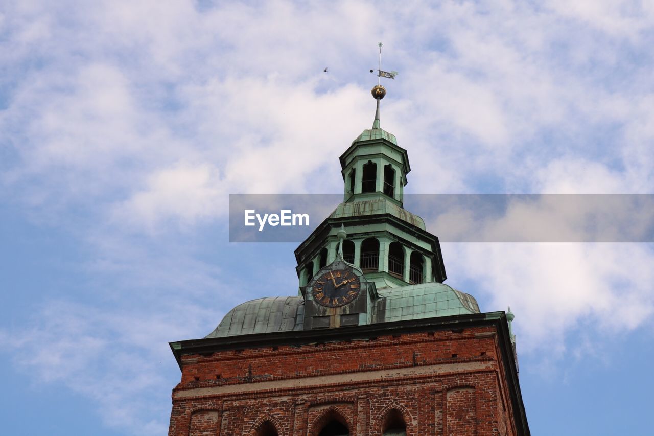 Low angle view of building against cloudy sky