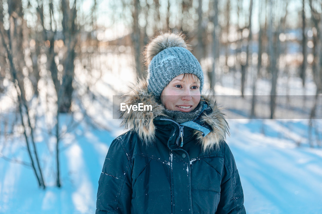 Portrait of smiling woman in snow