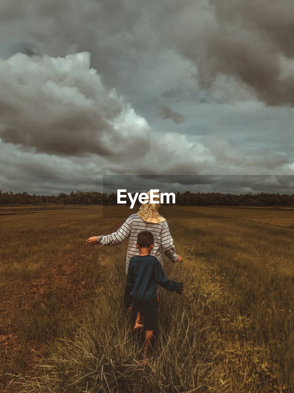 Woman on field against sky