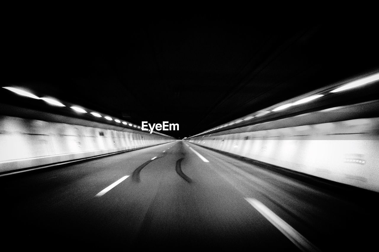 Blurred motion of highway against clear sky at night