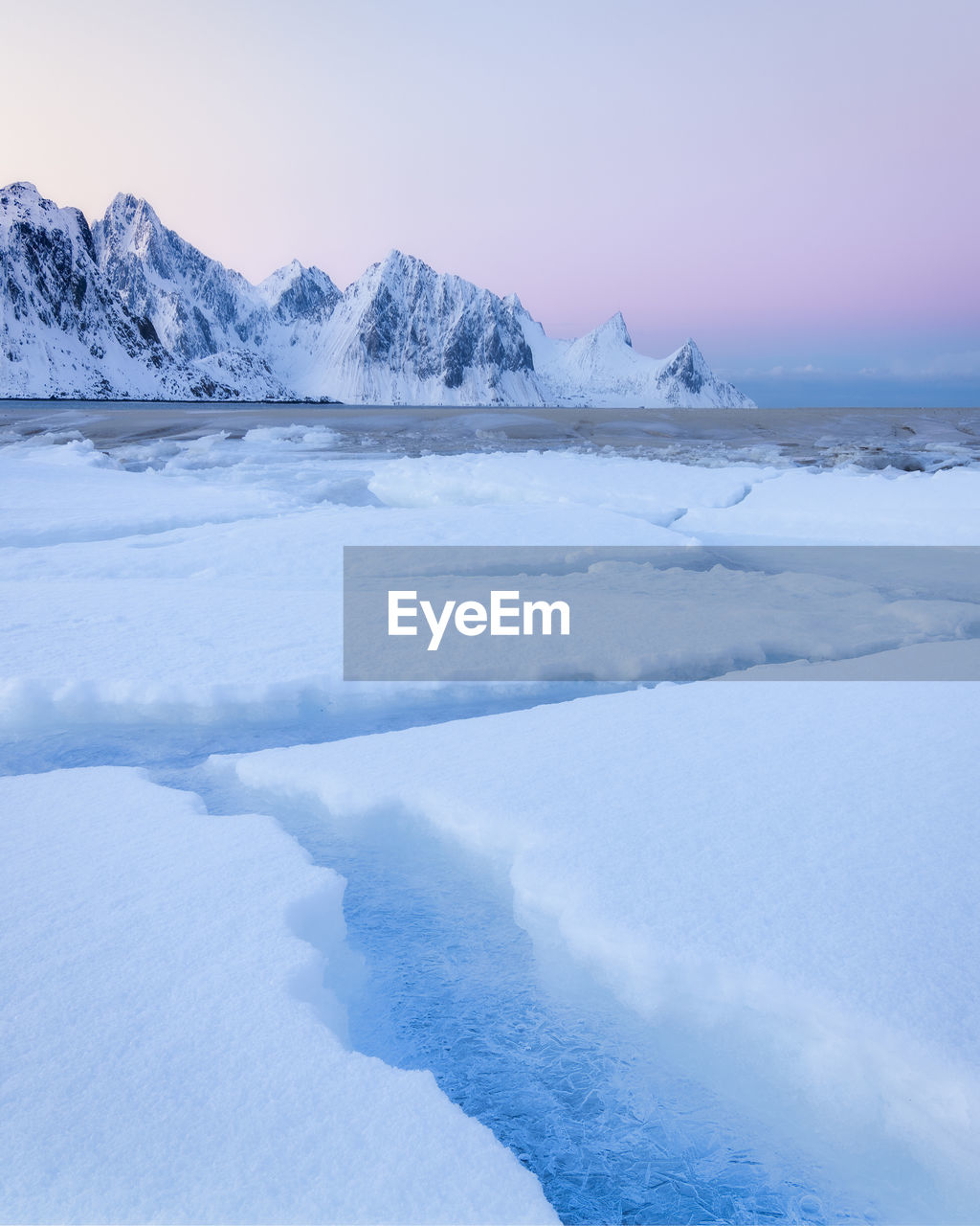 Beautiful calm cold morning on the lototen at haukland, with beautiful soft pink colors in the sky. 