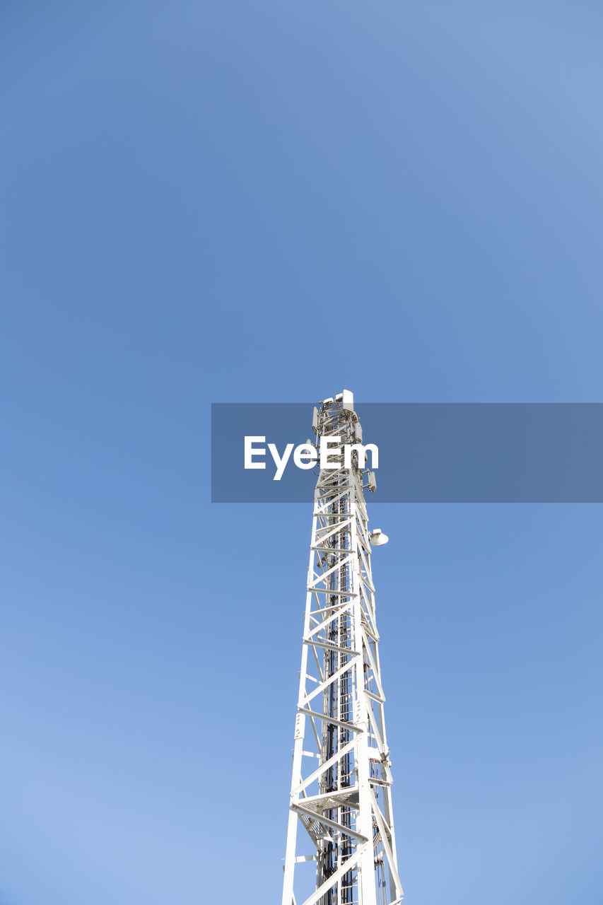 LOW ANGLE VIEW OF COMMUNICATIONS TOWER AGAINST SKY