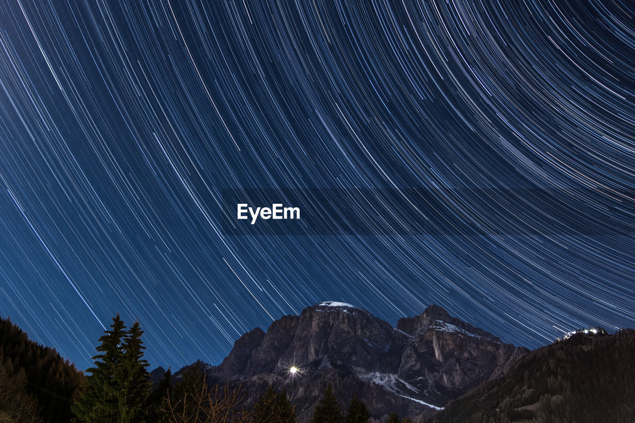 Scenic view of mountains against sky at night