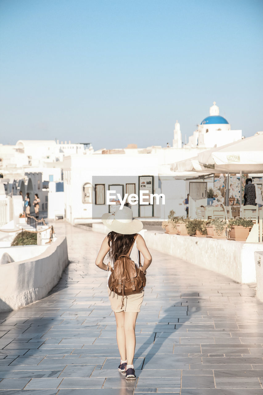 Woman standing in front of footpath