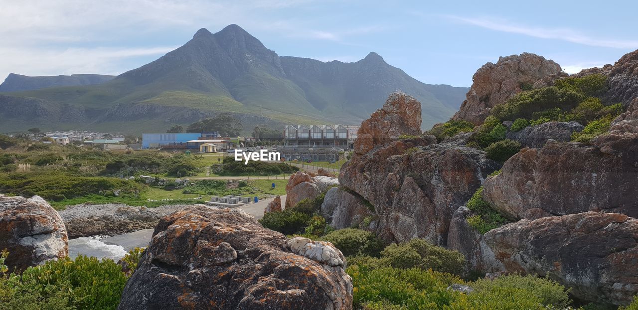 Scenic view of rocks and mountains against sky