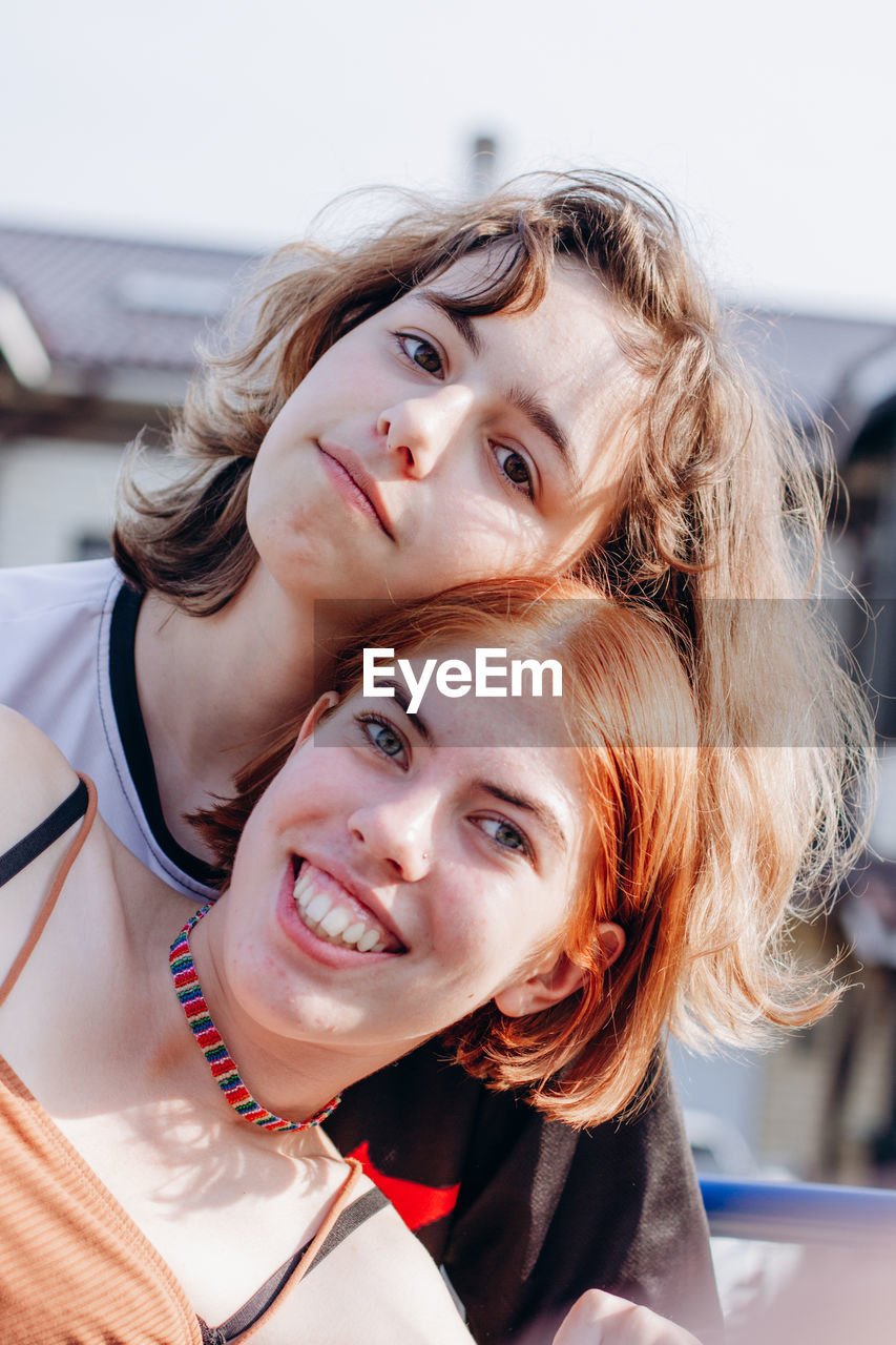 Two teenager girls together. girl friendship. red hair and curly hair