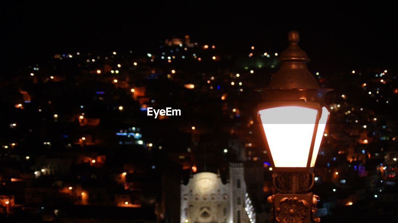 VIEW OF ILLUMINATED CITY AT NIGHT