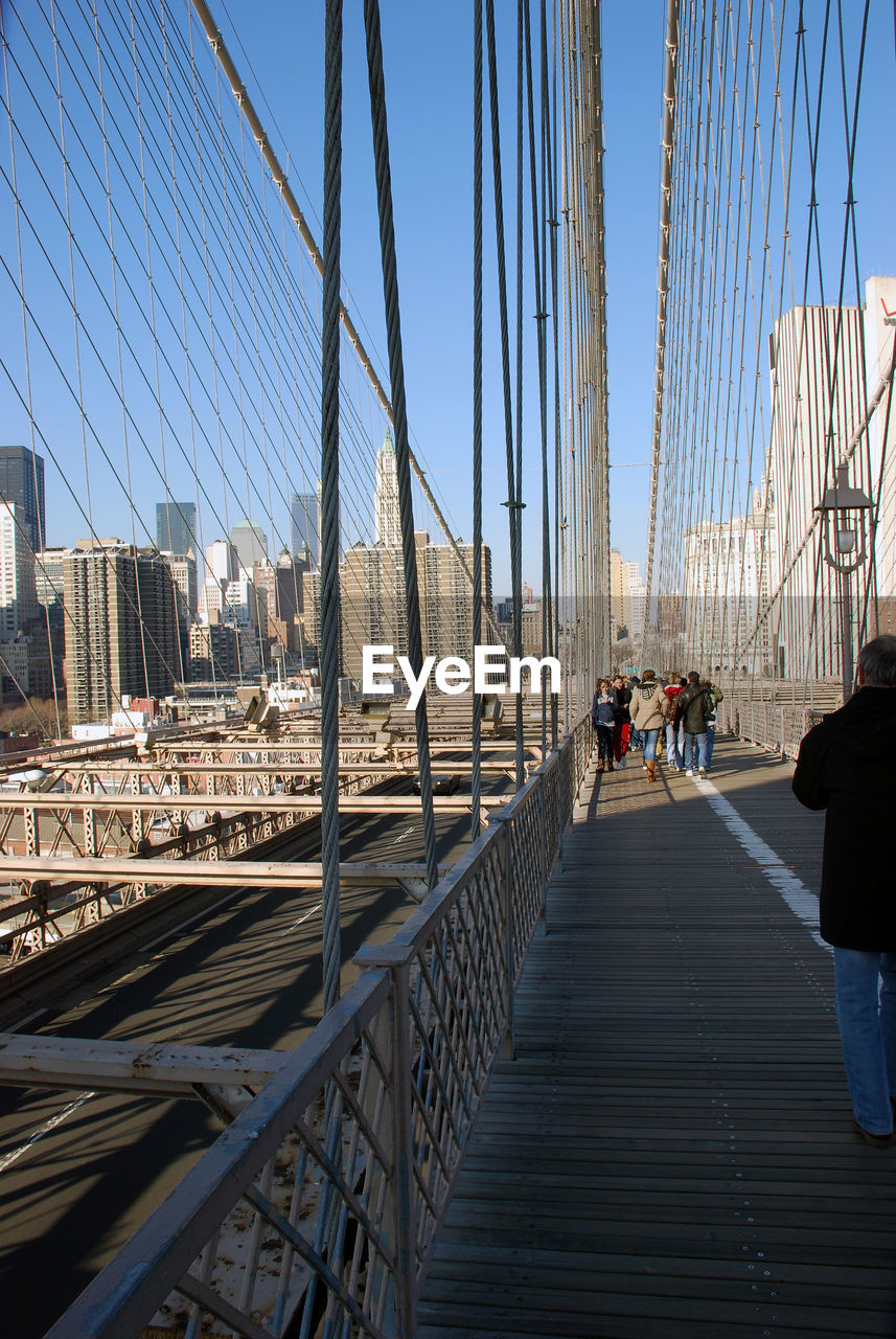 People walking on brooklyn bridge in new york city.