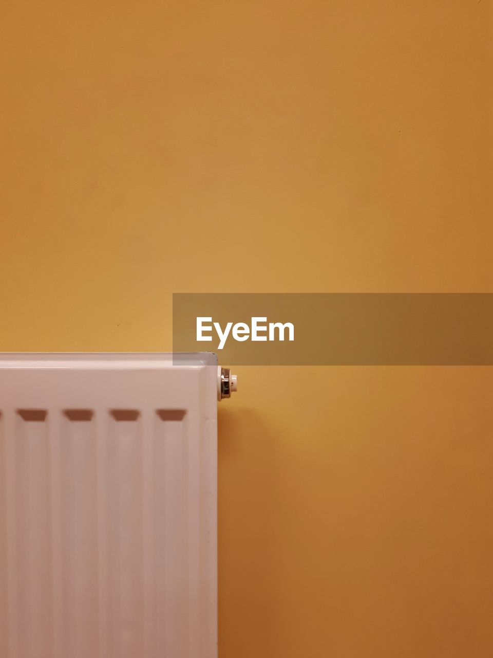  radiator against yellow wall