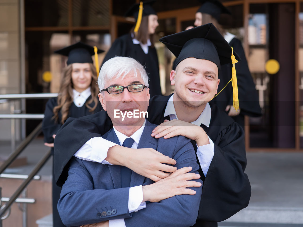 portrait of students wearing graduation gown