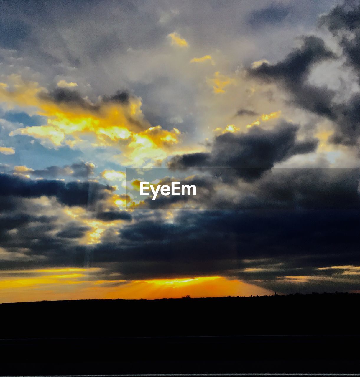 SCENIC VIEW OF SILHOUETTE LANDSCAPE AGAINST DRAMATIC SKY