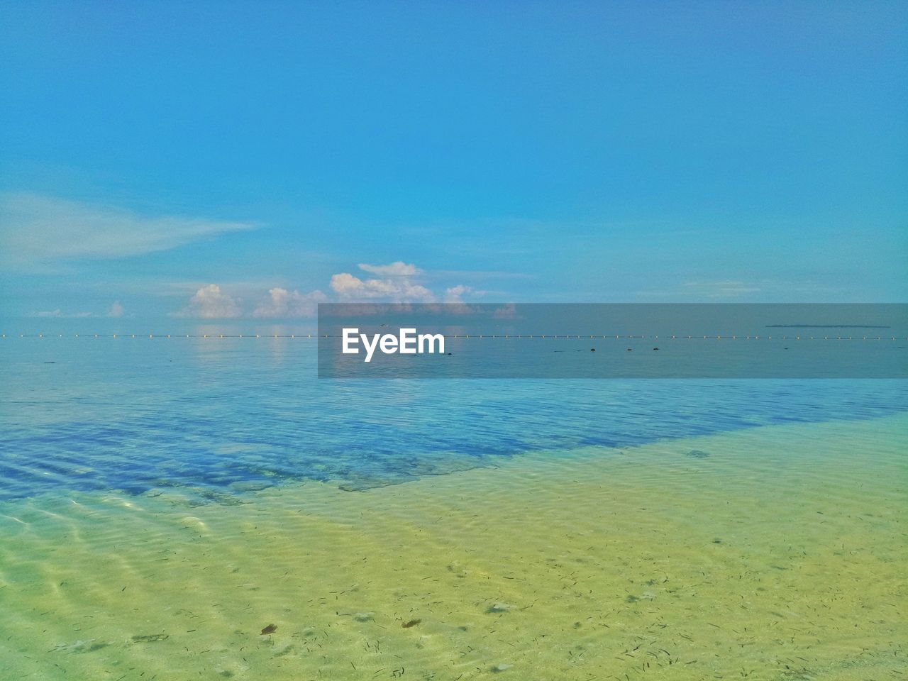 Scenic view of sea against blue sky