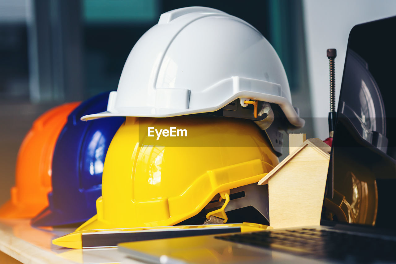 White, yellow and blue safety helmets for workers' safety projects in the position of engineers 