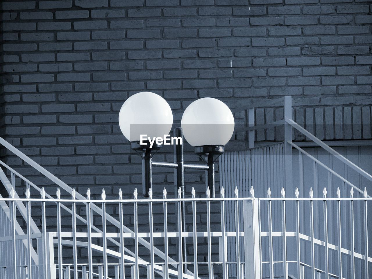 Low angle view of street light against wall