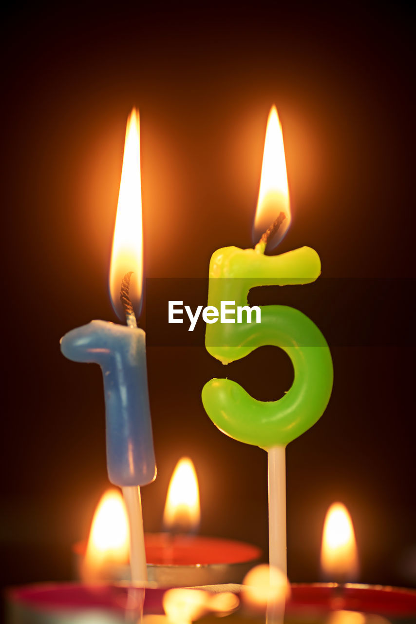 Close-up of illuminated birthday candles