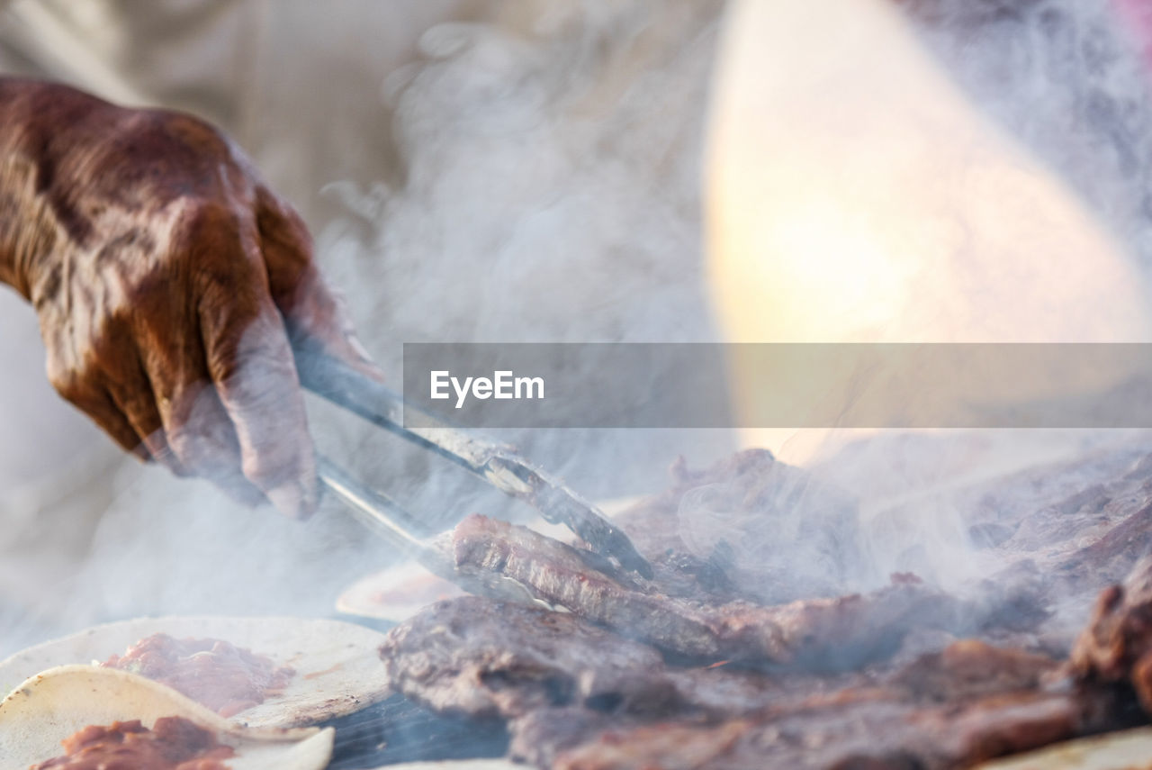 Midsection of man preparing food