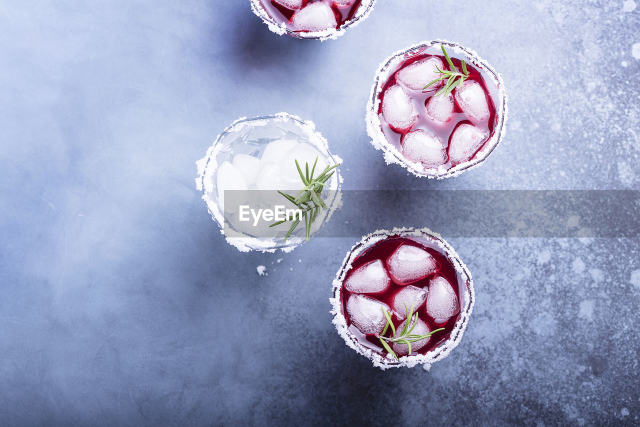 HIGH ANGLE VIEW OF ICE CREAM ON GLASS TABLE