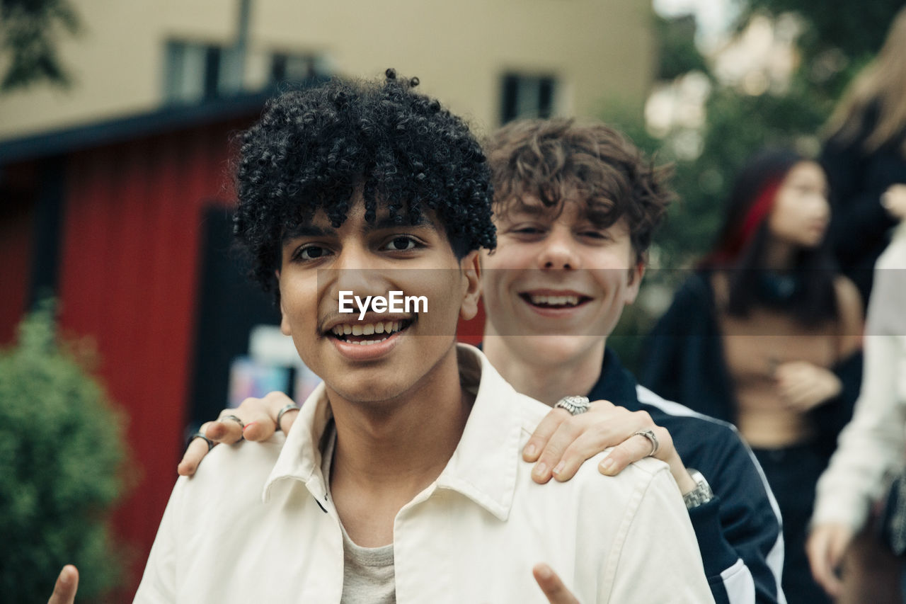 Portrait of smiling male friends in park