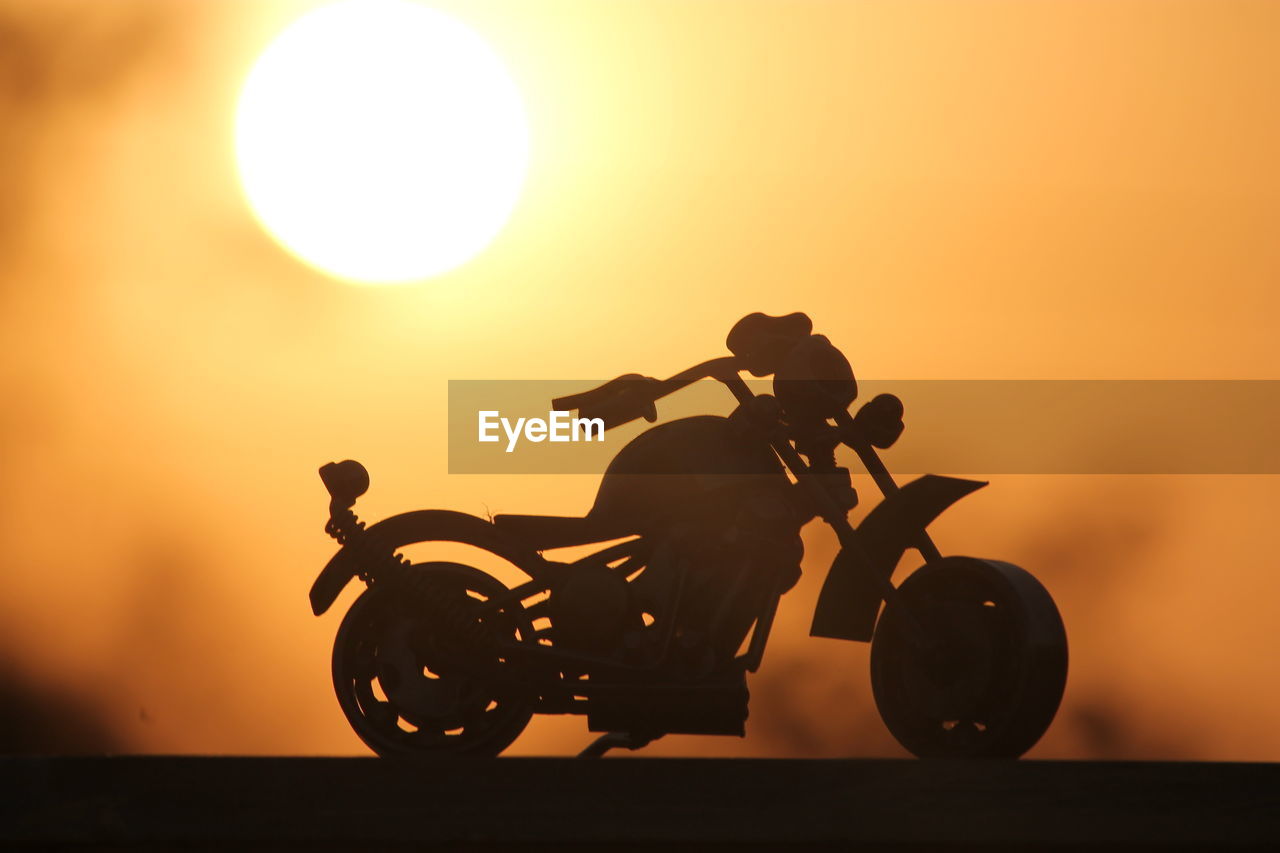 Motorcycle figurine on table during sunset